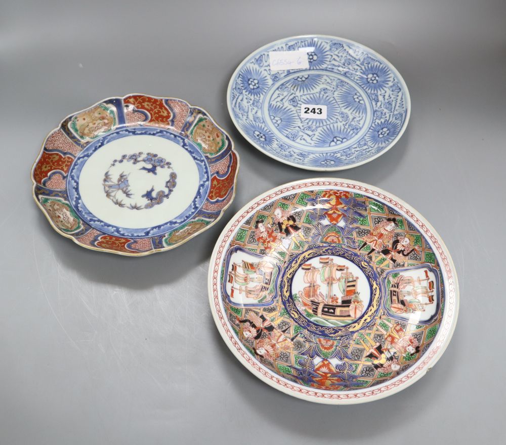 Two Japanese Arita dishes and a Chinese blue and white dish, largest diameter 24cm